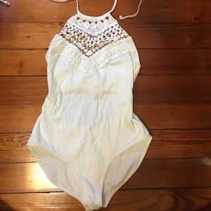 Out from under white bodysuit